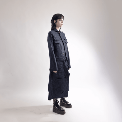 Person wearing a handmade silhouette skirt made from organic cotton, designed in Paris, paired with a matching jacket and platform shoes.